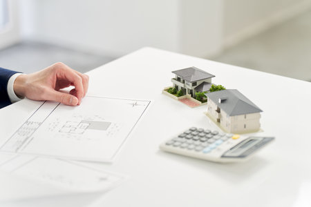 Businessman thinking about real estate floor planの写真素材