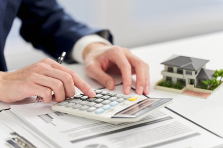 Businessman calculating money related to real estateの写真素材