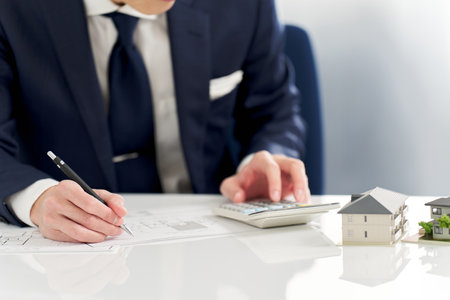 Businessman calculating the floor plan of real estateの写真素材