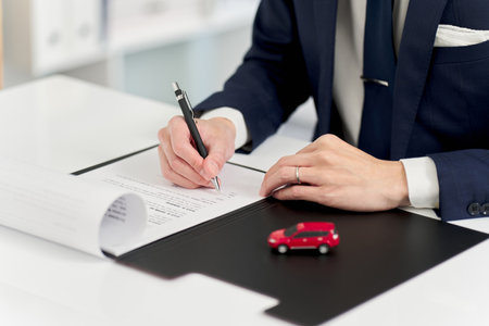 Businessman signing a car contractの写真素材