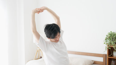 A man wakes up and stretchesの写真素材