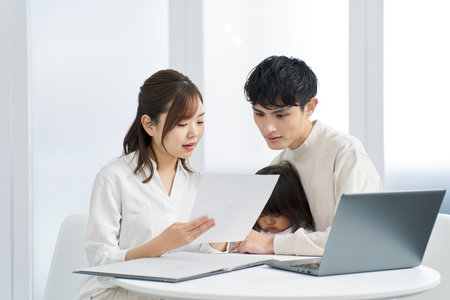 Asian family considering purchasing insuranceの写真素材