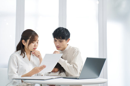 Asian family considering purchasing insuranceの写真素材