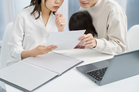 Asian family considering purchasing insuranceの写真素材