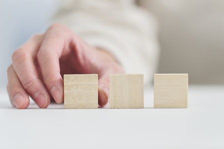 Hand holding a solid wooden block