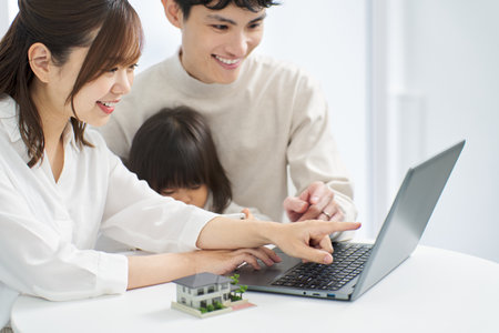 Asian family considering real estateの写真素材