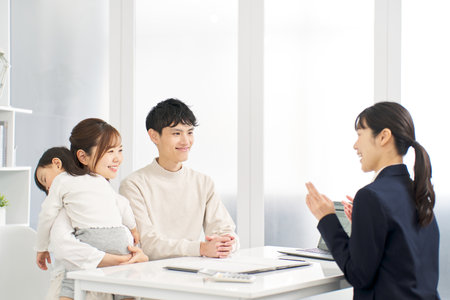 A family receiving information about insuranceの写真素材