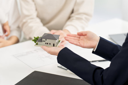 Hand of a business woman giving real estate informationの写真素材