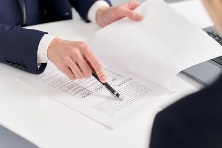Business person pointing out mistakes at workの写真素材