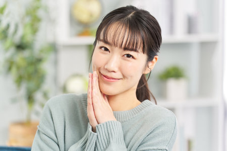 A woman who puts her hands together and asks for a favorの写真素材
