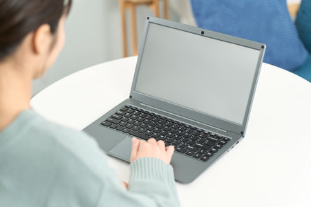 Woman surfing the internet in the living roomの写真素材