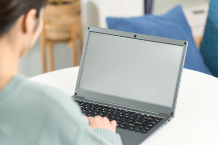 Woman surfing the internet in the living roomの写真素材
