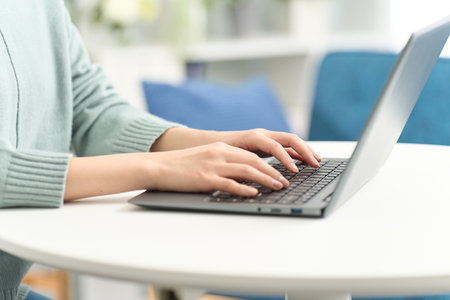 woman typing in the living roomの写真素材