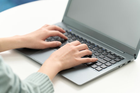 woman typing in the living roomの写真素材