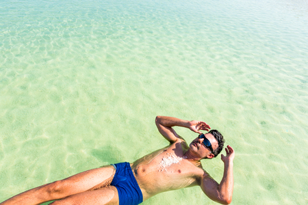 View of Dead Sea coastline. Salt crystals at sunset. Texture of Dead sea. Salty sea shoreの写真素材