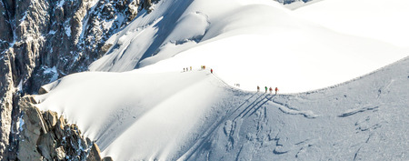 Mont Blanc mountaneers walking on snowy ridgeの写真素材