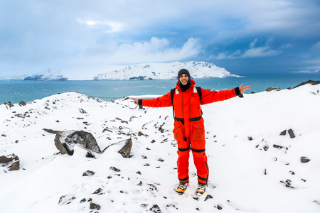 Man walks through ice and snow in Antarctica. Icebergs and everything frozen around you. Cold.の写真素材