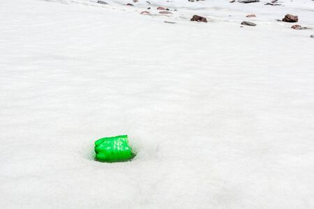 Garbage scattered over snowy mountain. Let's save the planet and recycle the excess garbage. Pollution Conceptの写真素材