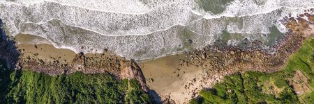Coastline with beach, mountains and blue ocean with waves in Brazil. Aerial view of Saquinho beach. Florianopolis Santa Catarina. SCの写真素材
