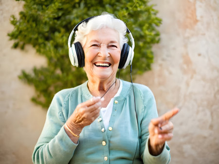 Close-up of senior woman listening to music on headphonesの素材