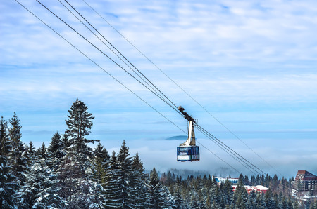 Skiing resort funicular with people moving uphill.の写真素材