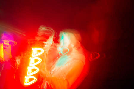 musician bass player in bright concert lighting long exposure without face