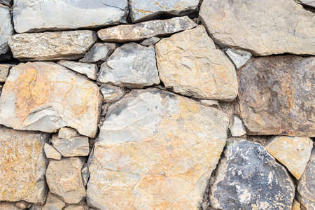 photo of a wall made of ancient rocksの写真素材