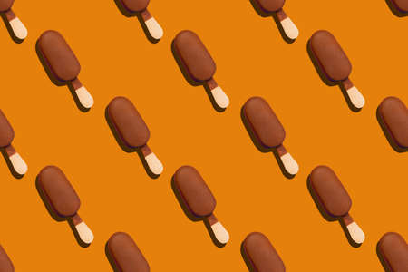 seamless pattern of a cold and delicious chocolade glazed eskimo on an orange background