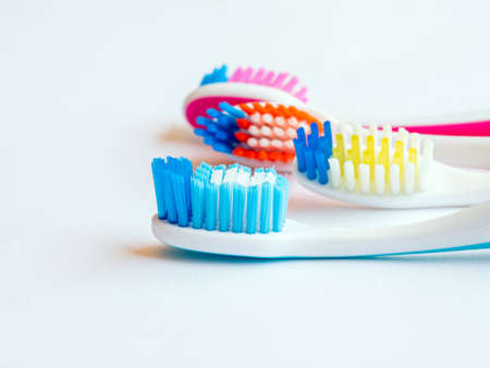 few different color toothbrushes heads. blue, orange, pink and yellowの写真素材
