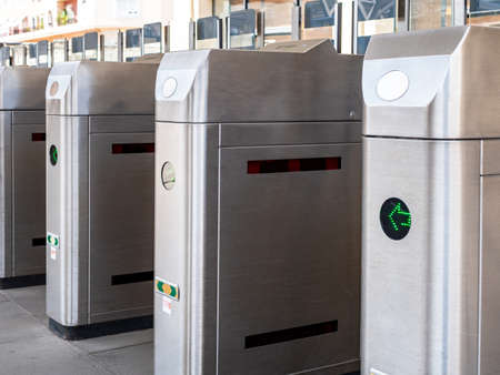 View of the station turnstiles waiting for crowds of passengers on a sunny day