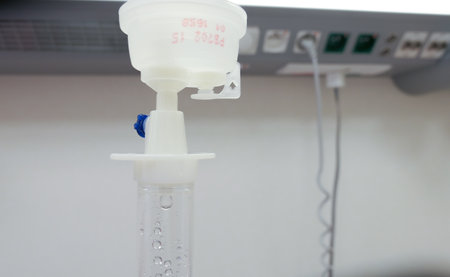 Fluid Drug Dripping from Intravenous Therapy Drip-Bag in Hospital Roomの写真素材