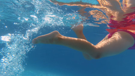 Underwater Little Girl Swimming in Swimming Pool Slow Motionの写真素材