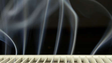 White Smoke Rising from Vent on Black Background