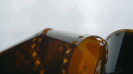 Watching Retro Pictures on Negative Plastic Film Strip Rollの写真素材
