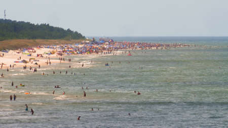 Landscape of Sandy Sea Beach People and Blue and Green Water at Baltic Seaの写真素材