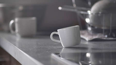 Coffee Cup Spinning Around and Standing on Kitchen Tableの写真素材