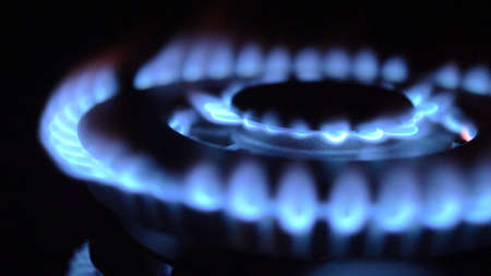 Gas Stove Turned On and Off with Blue Flames Fire in the Darkの写真素材