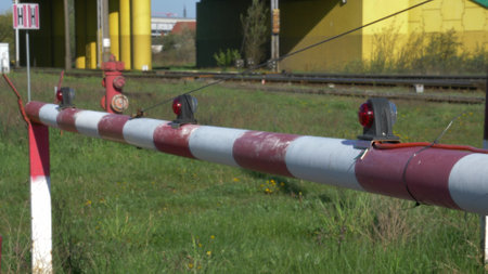 Flashing Red Signal Light on Railway Level Crossing Opening Barrier Close-Upの写真素材