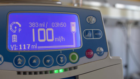Fluid Drug Dripping via Infusion Pump in Hospital Roomの写真素材