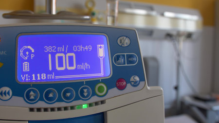 Fluid Drug Dripping via Infusion Pump in Hospital Roomの写真素材
