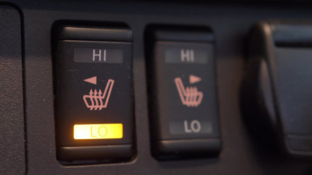 Heated Car Seat Switches Being Toggled to Control Seat Warmersの写真素材