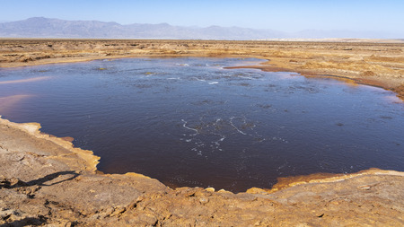 Acid bubbling pond in the Danakil depression in Ethiopia in Africa.