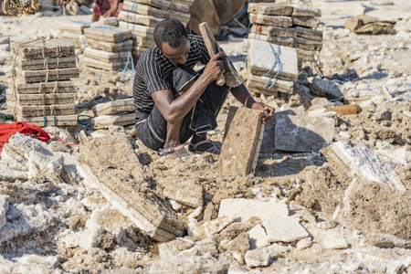 Salt miner working in the salt plains in the Danakil Depression in Ethiopia in winter.のeditorial素材