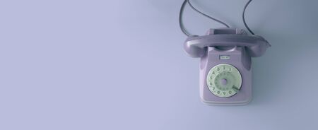 A violet vintage dial telephone with violet background.の写真素材