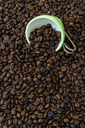 Green cup of coffee beans.の写真素材