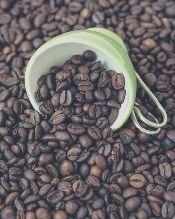 Green cup of coffee beans.の写真素材