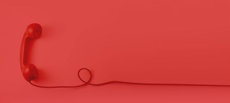 A red vintage dial telephone handset with red background.の写真素材