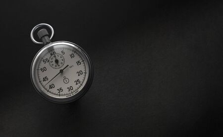 Vintage chronometer counting the passing time with black background.の写真素材