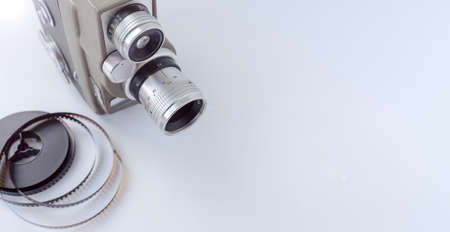 Vintage 8mm camera with 8mm reel on white background.の写真素材