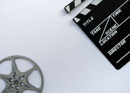 Close up of a vintage clapboard with 8mm filmstrip on white background.の写真素材